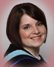 A woman with a graduation cap and gown