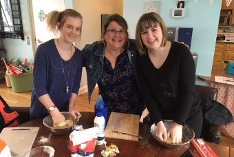 3 people posing while cooking