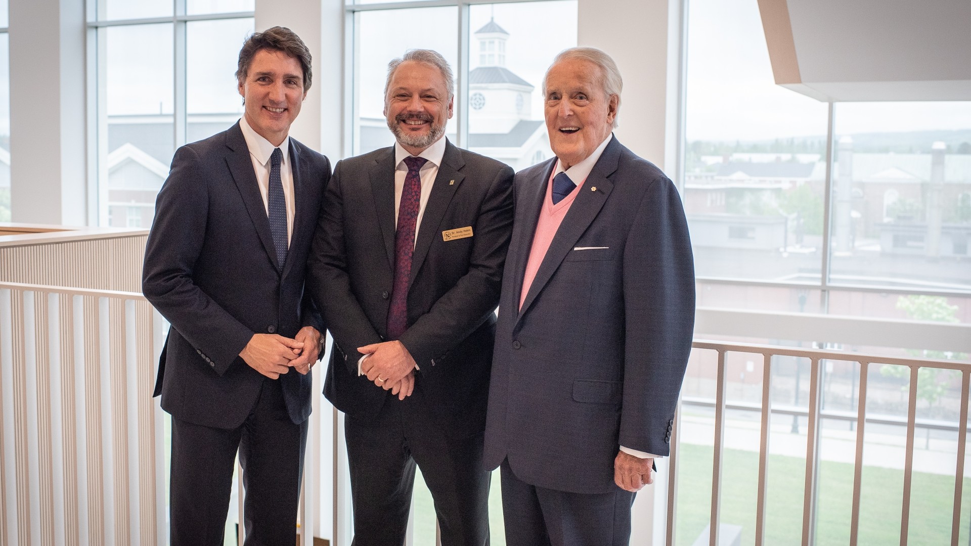 The StFX president standing with two Canadian Prime Ministers