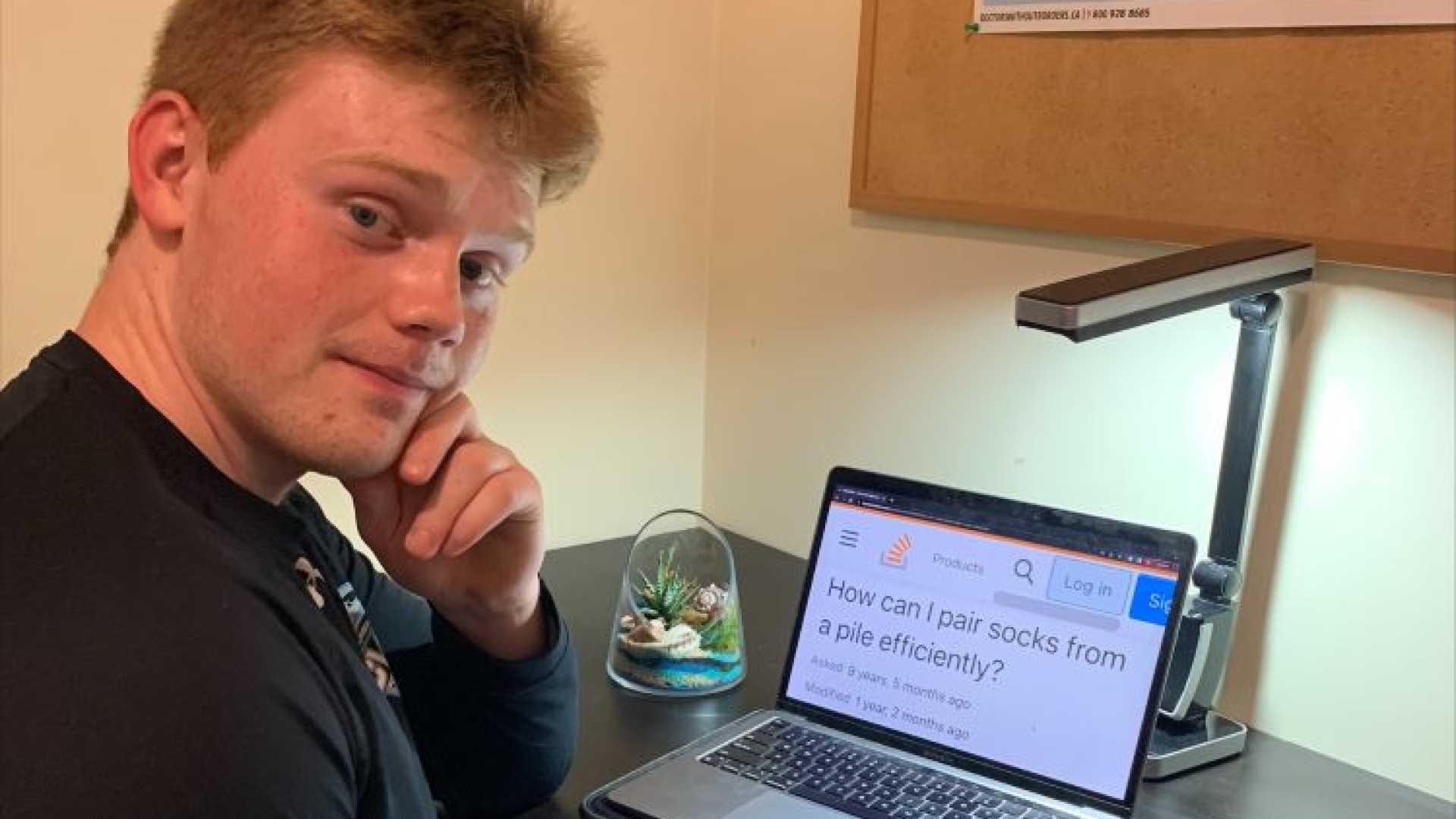 Student sitting at desk with computer 