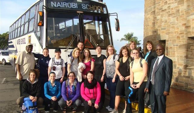 A group of people standing in front of a bus