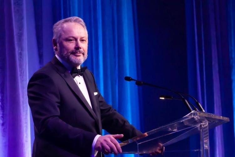 Dr. Andy Hakin at a podium