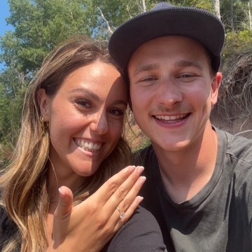 A young couple smiling on the day of their engagement