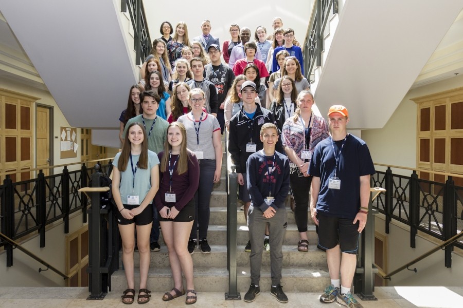 Group picture of math camp members in front of the stairs