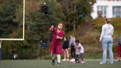 Mini U student playing lacrosse