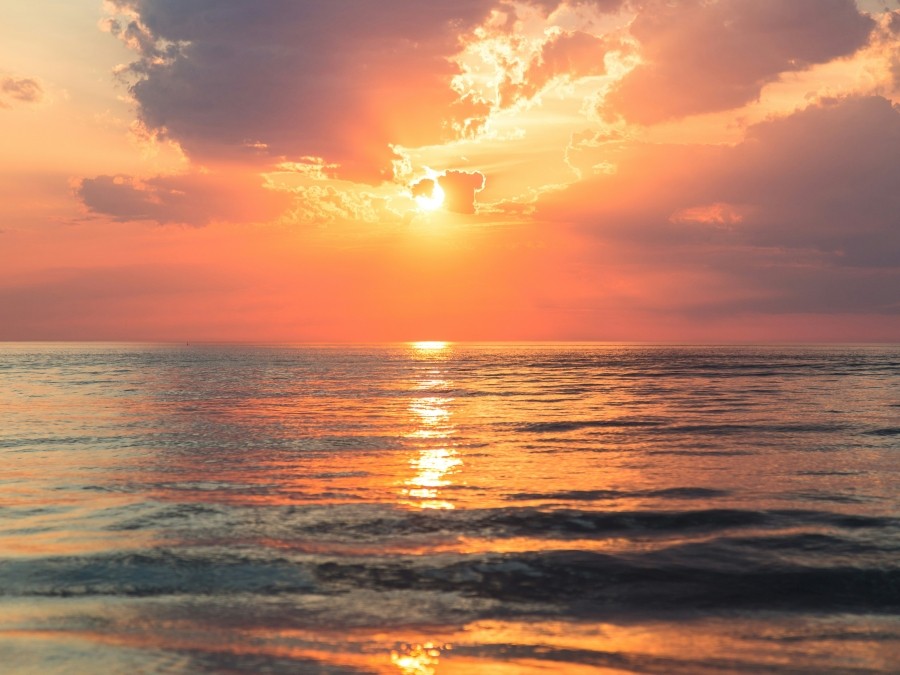 Sunrise over a large body of water.
